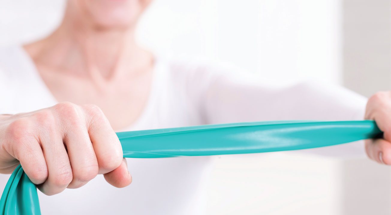 Woman holding Exercise band for Therapeutic exercises